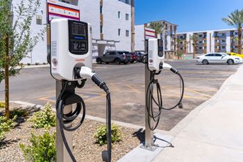 a pair of electric car chargers on the side of the road